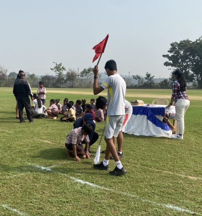 Raksheet volunteering at an outdoor sports day with rural schoolchildren