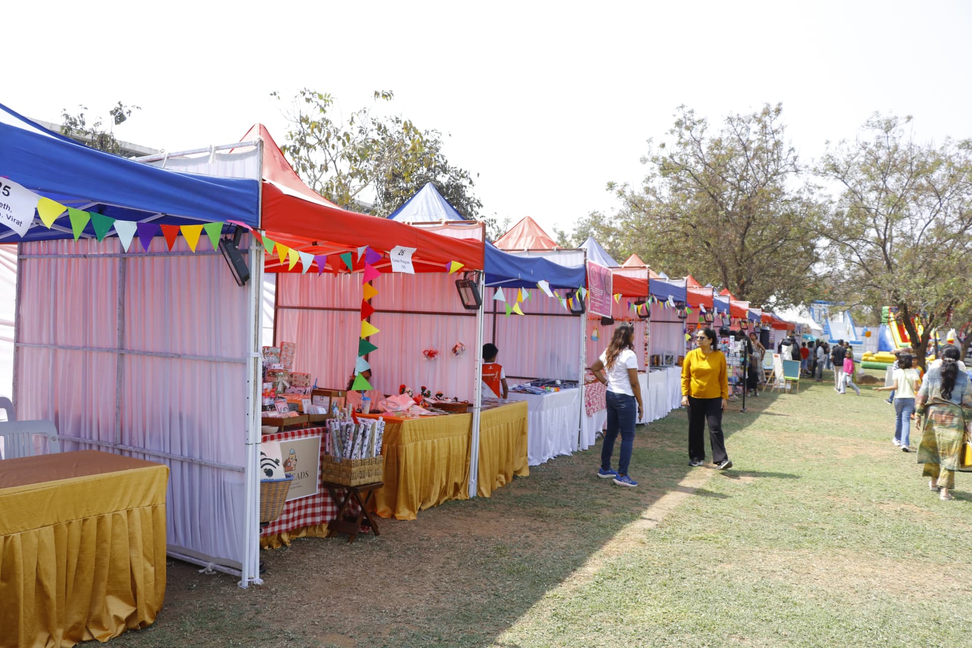 Colourful Fiesta stalls lined up under tents on the school grounds