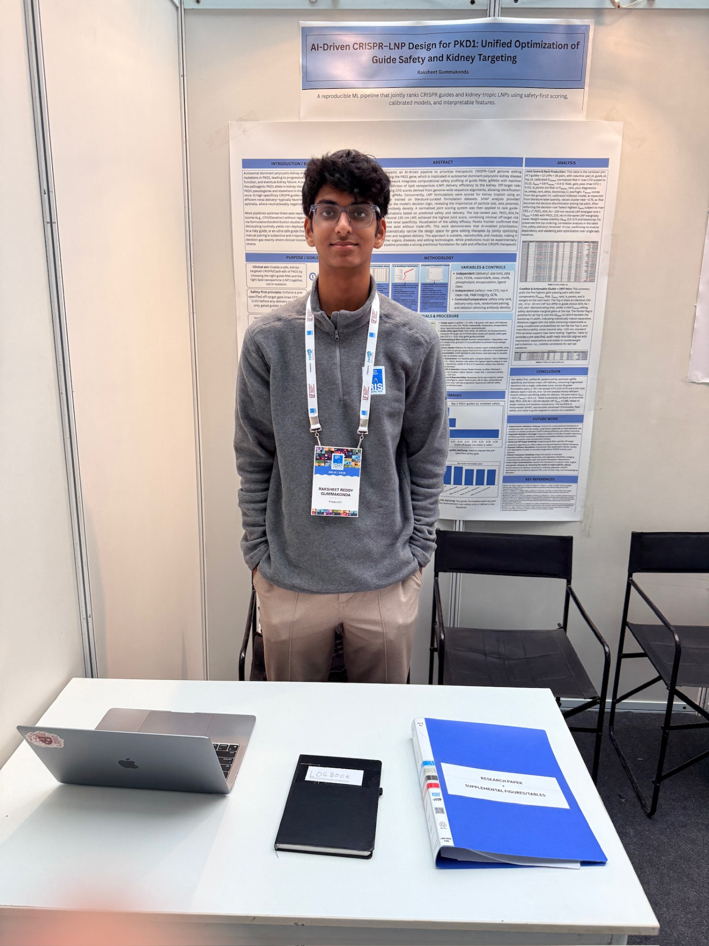 Raksheet Gummakonda standing in front of his research poster at the IRIS National Fair